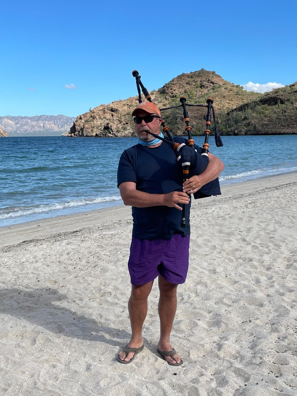 Owen Reid playing bagpipes on a Vancouver beach